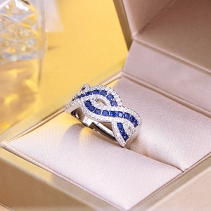 Luxurious silver infinity ring with sparkling blue and white cubic zirconia crystals
