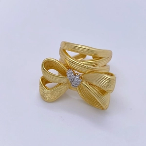 Elegant 18K gold-plated bow ring with brushed texture and center diamond accent
