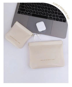Close-up of beige PU leather cable storage bags in two sizes with automatic spring closure