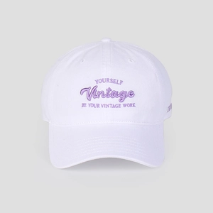 Detailed close-up of purple embroidery on a high-quality white cotton baseball cap