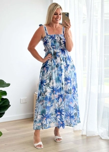 Detailed close-up of smocked bodice and tiered floral skirt on bohemian maxi dress