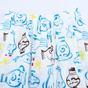 Close-up of elastic waistband and artistic hand-painted porcelain pattern on midi skirt
