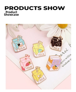 Detail of colorful milk box enamel pins in macaron tones with golden metal edges