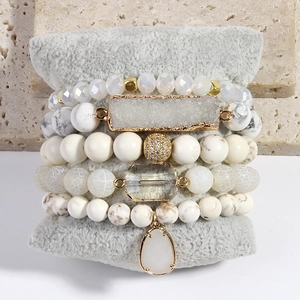 Detailed set of bohemian white and gold beaded bracelets featuring crystal stones and marble beads
