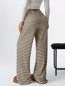 Detail view of the brown and white horizontal stripes on high-quality knit wide-leg pants