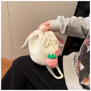Handmade crochet bunny ear bucket bag with strawberry charms and white knit pattern