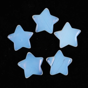 Detailed top-down view of five milky white star-shaped natural semi-precious stone carvings