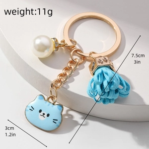 Detailed view of blue cat keychain with weight and size specifications for accessories