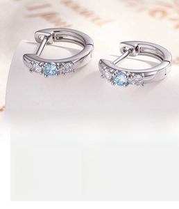Detail of silver copper hoop earrings featuring light blue zircon and 10mm inner diameter
