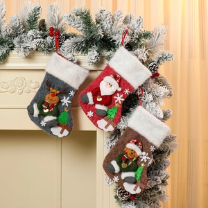 Three plush Christmas stockings with 3D Santa, Reindeer, and Bear motifs hanging on fireplace