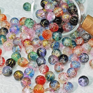 Mix of 10mm frosted glass beads with gold foil design spilling from a glass jar