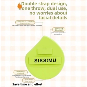 Detail of light green teardrop makeup puff with dual straps and slanted edge design