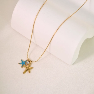 Starfish pendant necklace with blue enamel and crystal details on a gold chain