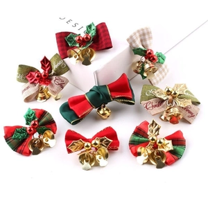 Detail of 8 Christmas linen bows with metal bells and holly berries decorations