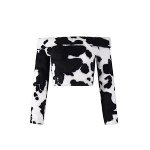 Detailed view of the soft cow print flannel fabric on this off-shoulder cropped long sleeve top