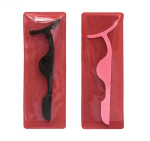 Detailed view of black and pink eyelash applicators in clear packaging on a white base