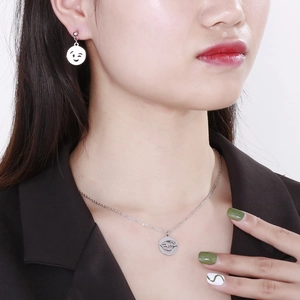 Silver stainless steel smile face necklace and earring set shown on model detail