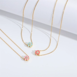 Three minimalist gold-tone necklaces with colorful enamel flower pendants and tiny zircons