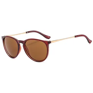 Vintage round sunglasses with reddish brown frames and golden metal temples in 45-degree view