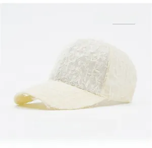 Close-up of beige baseball cap featuring unique fringed texture and premium cotton fabric