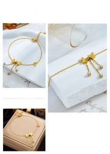 Detail of gold butterfly anklet with glitter fringe chains and crystal charms