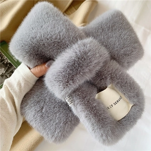 Detailed view of gray faux rabbit fur scarf featuring stitched brand and care labels
