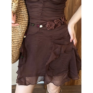 Detail of chiffon dress waist belt featuring fabric roses and colorful beads decor