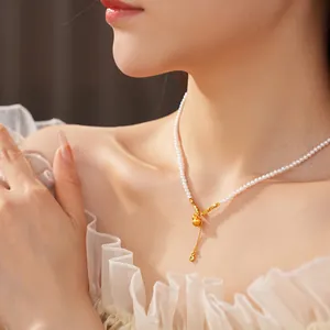 Elegant pearl necklace with golden gourd pendant and zircon charm on female model