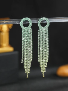 Macro shot of green rhinestone fringe earrings with elegant emerald gradient tassel details