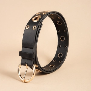 Detail of black PU leather belt with multiple rows of gold metal eyelets and ring buckle