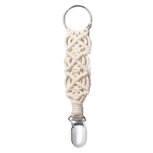 Detailed macro view of beige braided cotton hat clip with silver metal ring and clip holder