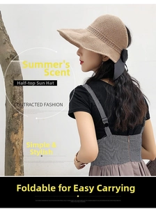 Detail of khaki straw sun hat featuring an open top design and elegant black bow