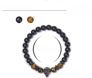 Detail of 8mm tiger eye bead bracelet featuring a carved wolf head and micro-pave spacers