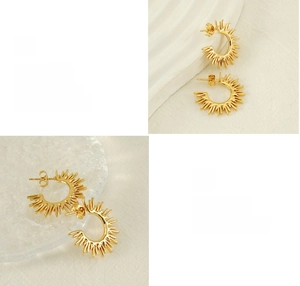 Detailed view of gold sunburst textured earrings with polished finish and plating