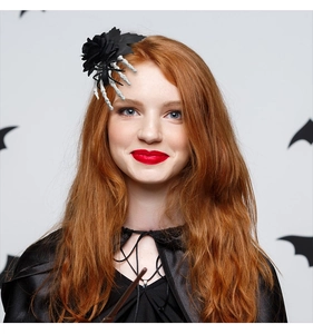 Detail of Halloween hair clip with black rose and skeleton spider hand on model hair