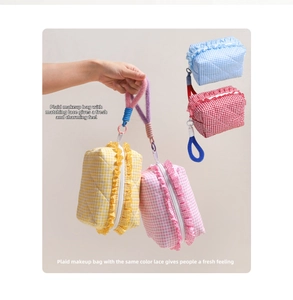 Detailed close-up of quilted cotton cosmetic bags with ruffle edges and colorful plush ropes