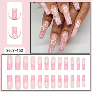 Long coffin pink gradient press-on nails with white cherry blossoms and tiny rhinestones
