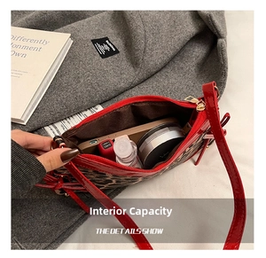 Internal capacity of leopard print shoulder bag showing phone and cosmetics