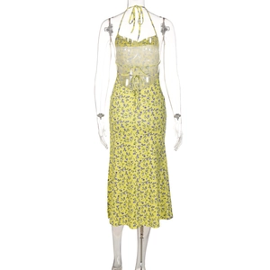Detail of the back of a floral sundress with cross-strap back and a thigh-high side slit