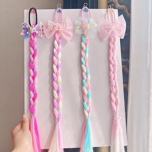 Detail showing 4 colorful synthetic hair braid extensions with cute cartoon ornaments