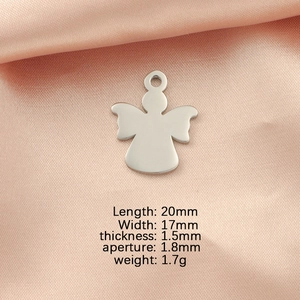 Polished stainless steel angel pendant with precise measurements on pink fabric background