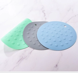 Detailed view of three silicone round placemats with dot pattern and hanging hole
