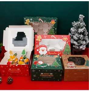 Detailed view of Christmas cupcake boxes in red and green with clear windows and festive prints