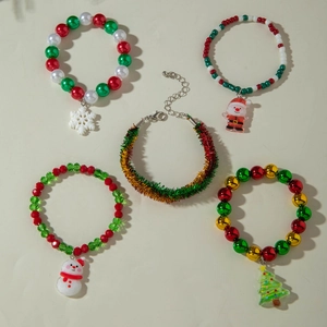 Set of 5 Christmas charm bracelets featuring Santa, snowman, and tree beads on beige background