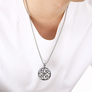 Macro detail of Viking Odin rune compass pendant on a silver box chain for men
