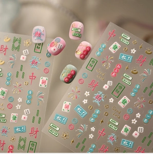 Detail of Mahjong nail art stickers with red and gold festive Chinese characters and luck motifs