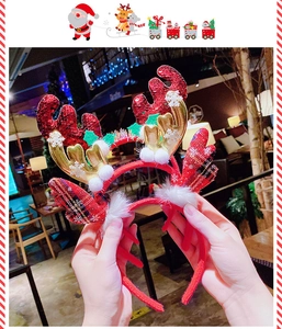 Detail of glitter reindeer antlers headband with white plush balls for Christmas party