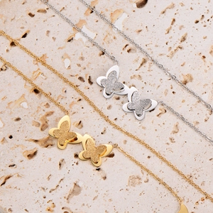 Frosted butterfly necklaces in gold and silver on stone, minimalist stainless steel design