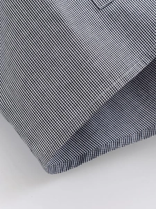 Detail of classic black and white houndstooth pattern and high-quality sewing stitch