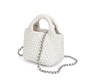 Detailed view of white hand-woven bucket bag with intricate leather texture and chain